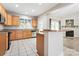 Well-lit kitchen with wood cabinetry, black appliances, tiled flooring, and breakfast bar that opens to the dining area at 145 Mcbride Dr, Rockwell, NC 28138