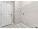 Utility room with tile floors, wire rack shelving, and convenient laundry hook-ups at 145 Mcbride Dr, Rockwell, NC 28138