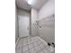 Functional laundry room with tile flooring, a door, and wire shelving at 145 Mcbride Dr, Rockwell, NC 28138