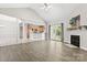 Bright living room with wood floors, fireplace, and view of the kitchen at 145 Mcbride Dr, Rockwell, NC 28138