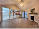 Open-concept living room with fireplace flows seamlessly into kitchen and dining area at 145 Mcbride Dr, Rockwell, NC 28138