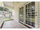 Cozy outdoor patio with double doors to home and view of treed backyard at 145 Mcbride Dr, Rockwell, NC 28138
