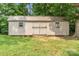 Close up view of a gray storage shed in the backyard, with double doors and two windows at 145 Mcbride Dr, Rockwell, NC 28138