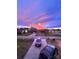 A street view with a dramatic sunset and well-manicured front lawns at 145 Mcbride Dr, Rockwell, NC 28138