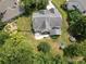 Aerial view of a backyard, highlighting its spaciousness, patio area, garden, playground, and surrounding mature trees at 1800 Robbins Meadows Dr, Waxhaw, NC 28173