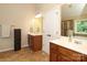 Double vanity in the bathroom with dark wood cabinetry at 1800 Robbins Meadows Dr, Waxhaw, NC 28173