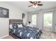 A bedroom with a bed with an elephant print and lion-themed decor and a cozy armchair at 1800 Robbins Meadows Dr, Waxhaw, NC 28173