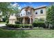 Charming two-story home with a manicured lawn, stone accents, and an American flag on the porch at 1800 Robbins Meadows Dr, Waxhaw, NC 28173