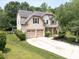 Beautiful two-story home featuring a well-manicured lawn, a two-car garage, and charming front porch landscaping at 1800 Robbins Meadows Dr, Waxhaw, NC 28173