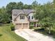 Beautiful exterior showcasing a well-maintained lawn, a two-car garage, and a charming front porch at 1800 Robbins Meadows Dr, Waxhaw, NC 28173