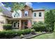 Charming home with a covered porch, stone accents, manicured landscaping, and an inviting front entrance at 1800 Robbins Meadows Dr, Waxhaw, NC 28173