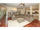 Open-concept living room featuring hardwood floors, a large sectional, and seamless access to the kitchen at 1800 Robbins Meadows Dr, Waxhaw, NC 28173