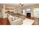 Open-concept living room featuring hardwood floors, a fireplace, and modern decor at 1800 Robbins Meadows Dr, Waxhaw, NC 28173
