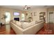 Living room featuring hardwood floors, fireplace, and view into another room at 1800 Robbins Meadows Dr, Waxhaw, NC 28173