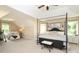 Spacious primary bedroom featuring a sitting area, large windows, and a four-poster bed at 1800 Robbins Meadows Dr, Waxhaw, NC 28173