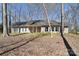 Beautiful ranch-style home with a covered porch and neutral siding amidst lovely trees at 2010 Creekwood Dr, York, SC 29745