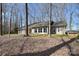 Lovely single story ranch house with black shutters, light siding and surrounded by trees at 2010 Creekwood Dr, York, SC 29745