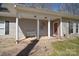 Inviting front porch with a sitting bench, brick walkway, and a red front door at 2010 Creekwood Dr, York, SC 29745