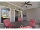 Covered patio features ceiling fan and outdoor seating for relaxing and entertaining at 2010 Creekwood Dr, York, SC 29745