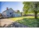 Backyard featuring mature tree, swing set, partially fenced yard and blue house siding at 209 W Church St, China Grove, NC 28023