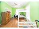 Bright bedroom with a bunk bed, ceiling fan, wood floors and a four drawer wood dresser at 209 W Church St, China Grove, NC 28023