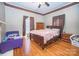 Comfortable bedroom with hardwood floors, ceiling fan, and neutral-colored walls at 209 W Church St, China Grove, NC 28023