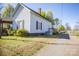 View of a home featuring green grass, blue siding, small porch and a driveway at 209 W Church St, China Grove, NC 28023