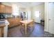 Charming kitchen featuring a dining table, stainless steel refrigerator, tiled floor and white cabinets at 209 W Church St, China Grove, NC 28023