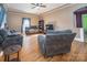 Comfortable living room with hardwood floors, ceiling fan, and lots of natural light at 209 W Church St, China Grove, NC 28023