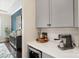 A stylish bar area featuring light gray cabinets and quartz countertops with a beverage fridge at 2150 Paddlers Cove Dr, Clover, SC 29710