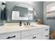 A bright bathroom with a white vanity, arched mirror, and modern fixtures at 2150 Paddlers Cove Dr, Clover, SC 29710