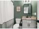 Well-lit bathroom featuring green walls, framed art and a vanity at 2150 Paddlers Cove Dr, Clover, SC 29710