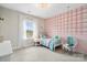 Bright bedroom with a playful pink wall, hanging chair, and a window overlooking the outside at 2150 Paddlers Cove Dr, Clover, SC 29710