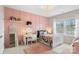 Stylish bedroom with pink paneling, decorative shelves, and a cozy bed with floral accents at 2150 Paddlers Cove Dr, Clover, SC 29710