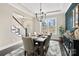 Bright dining room featuring hardwood floors, large windows, modern lighting, and seating for six at 2150 Paddlers Cove Dr, Clover, SC 29710