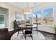 Light-filled dining area with round table, large windows, and modern chandelier at 2150 Paddlers Cove Dr, Clover, SC 29710