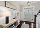 Welcoming foyer with dark wood floors, white wainscoting, stylish lighting, and decorative table at 2150 Paddlers Cove Dr, Clover, SC 29710