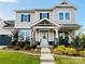 Charming two-story home showcasing a light-blue front door, well-kept lawn, and beautifully landscaped flowerbeds at 2150 Paddlers Cove Dr, Clover, SC 29710