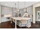 A full kitchen view featuring a central island, gray cabinets, and stainless steel appliances at 2150 Paddlers Cove Dr, Clover, SC 29710