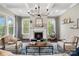 Cozy living room with a fireplace, coffered ceiling, and ample natural light at 2150 Paddlers Cove Dr, Clover, SC 29710