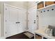 Hallway with access to closet and garage features wainscoting, a bench, and storage baskets at 2150 Paddlers Cove Dr, Clover, SC 29710