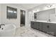 Modern bathroom with a soaking tub, glass shower, and double sink vanity at 3041 Tramore Dr, Harrisburg, NC 28075