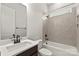 A modern bathroom featuring dark fixtures, neutral tiling and a shower/tub combo at 3041 Tramore Dr, Harrisburg, NC 28075