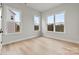 Bright bedroom featuring hardwood floors and multiple windows providing natural light at 3041 Tramore Dr, Harrisburg, NC 28075