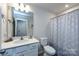 Well-lit bathroom with a modern vanity, sleek faucet, and decorative shower curtain for a fresh, clean look at 3100 Cheyney Park Dr, Charlotte, NC 28269