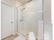 Modern bathroom with a glass enclosed shower, tile surround, and white trim door at 3100 Cheyney Park Dr, Charlotte, NC 28269