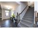 Inviting foyer with hardwood floors, staircase, and decorative accents creating a warm and welcoming entrance at 3100 Cheyney Park Dr, Charlotte, NC 28269