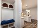 Hallway entrance adjacent to a kitchen featuring a built-in bench with storage and a modern design at 3100 Cheyney Park Dr, Charlotte, NC 28269