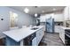 Bright kitchen island featuring a sink, stainless steel appliances, and modern fixtures at 3100 Cheyney Park Dr, Charlotte, NC 28269