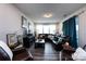 Open living room area featuring a cozy leather sectional and hardwood style flooring at 3100 Cheyney Park Dr, Charlotte, NC 28269